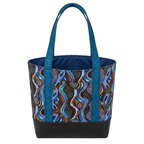 Handmade cotton tote bag with abstract wave pattern in blue and brown tones, teal handles, and structured black base