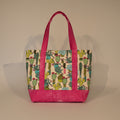 Fabric bag with cactus pattern and pink border on a plain background