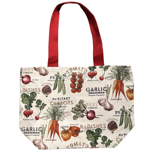 Handmade canvas tote bag featuring colorful heirloom vegetables with red canvas handles.