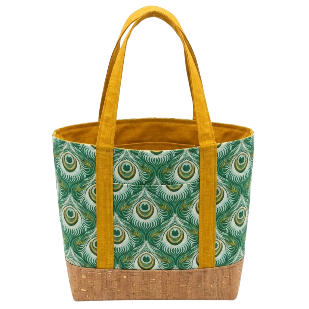 Handmade cotton tote bag with earth-toned owl pattern, forest green handles, and structured black base