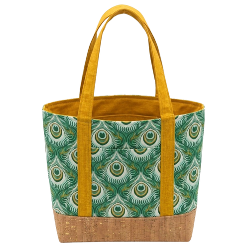 Handmade cotton tote bag with earth-toned owl pattern, forest green handles, and structured black base
