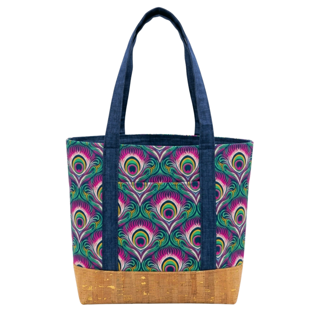 Handmade cotton tote bag with bold peacock eye pattern, navy straps, and cork base with gold flecks