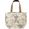 Handmade canvas tote bag featuring vintage butterflies, dragonflies, botanical illustrations, and postal artwork with tan canvas handles.