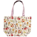 Handmade canvas tote bag featuring watercolor wildflowers on a cream background with soft lilac canvas handles.