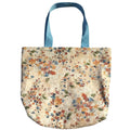 Oversized handmade floral canvas tote bag with watercolor wildflower print and light blue shoulder straps