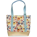 Handmade cotton tote bag featuring colorful wildflowers with sky blue handles and ivory faux leather base