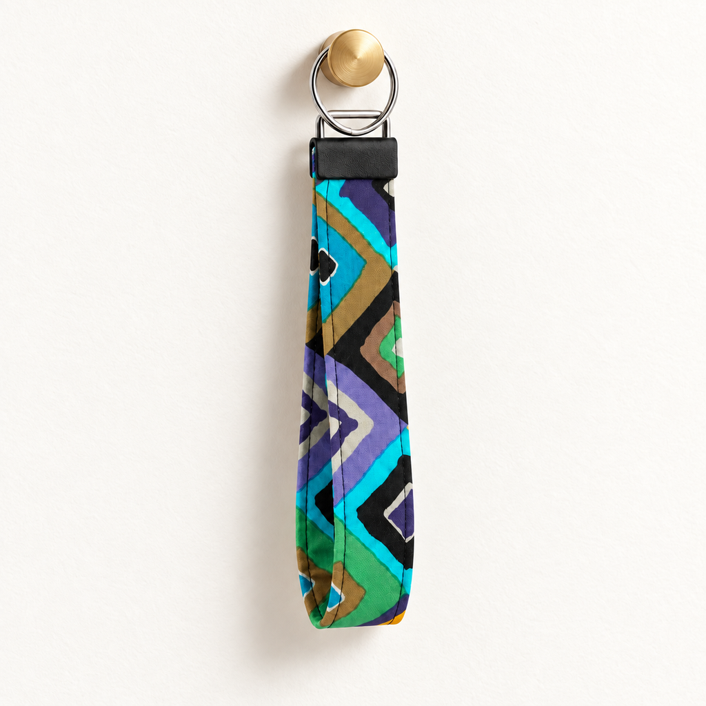Angle Management – Fabric Wristlet Keychain hanging from a gold wall knob