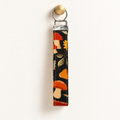 Bloom & Shroom – Fabric Wristlet Keychain hanging from a gold wall knob
