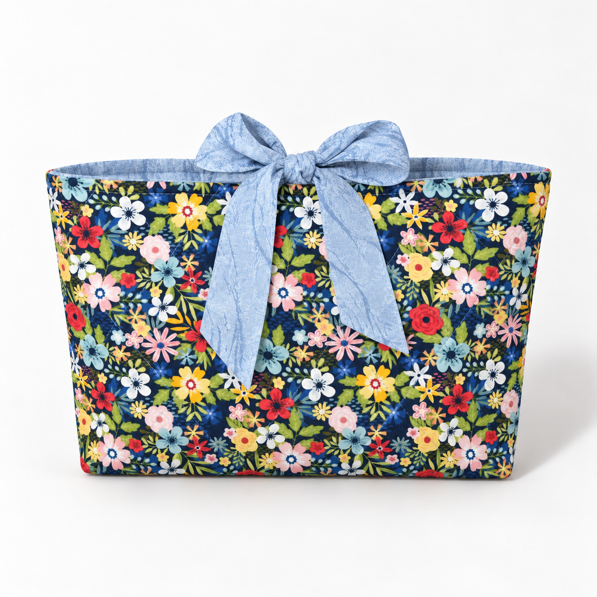 Bloom Between the Lines book sleeve with rounded pale blue patterned bow, front view