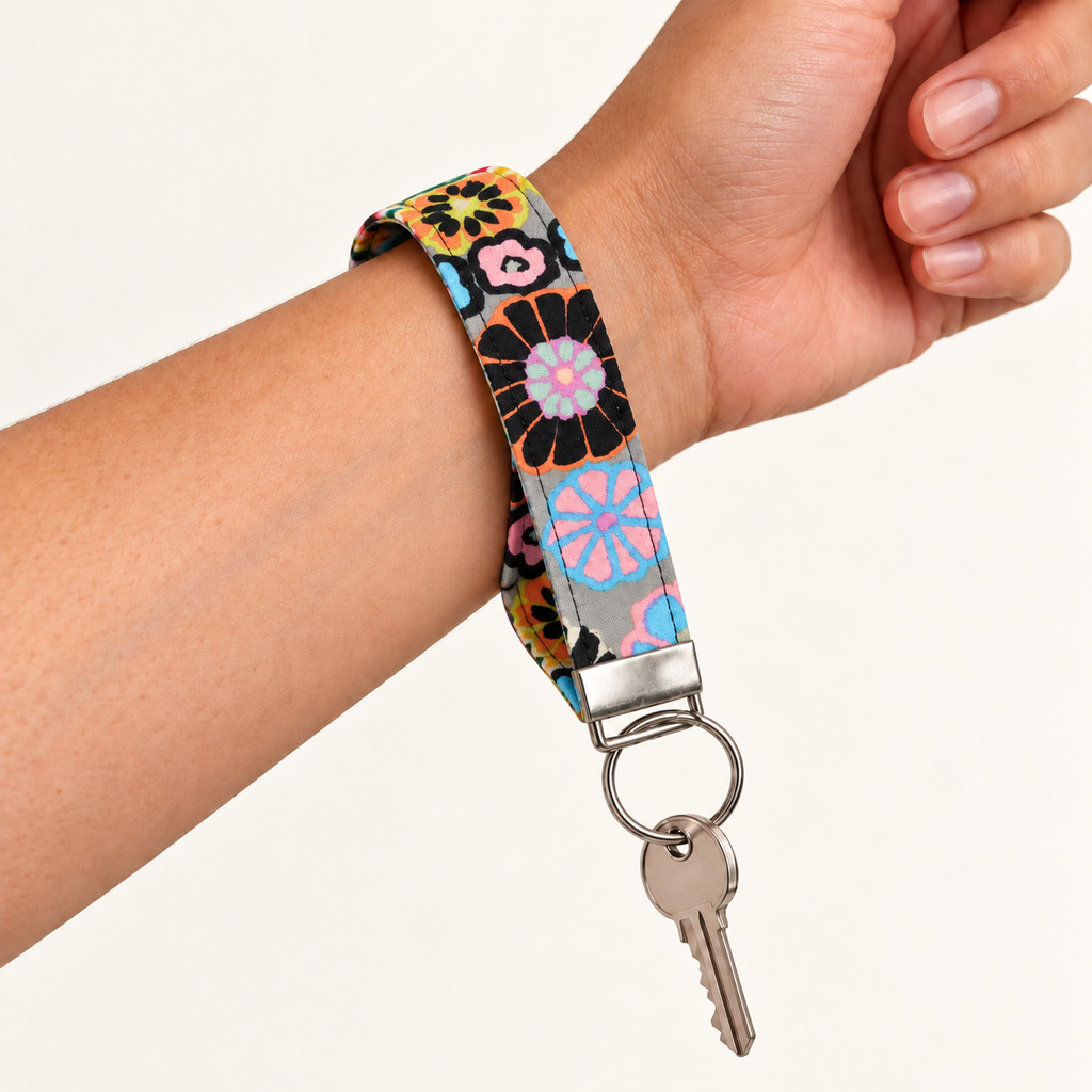 Bloom With Attitude – Fabric Wristlet Keychain worn around a wrist with a key attached