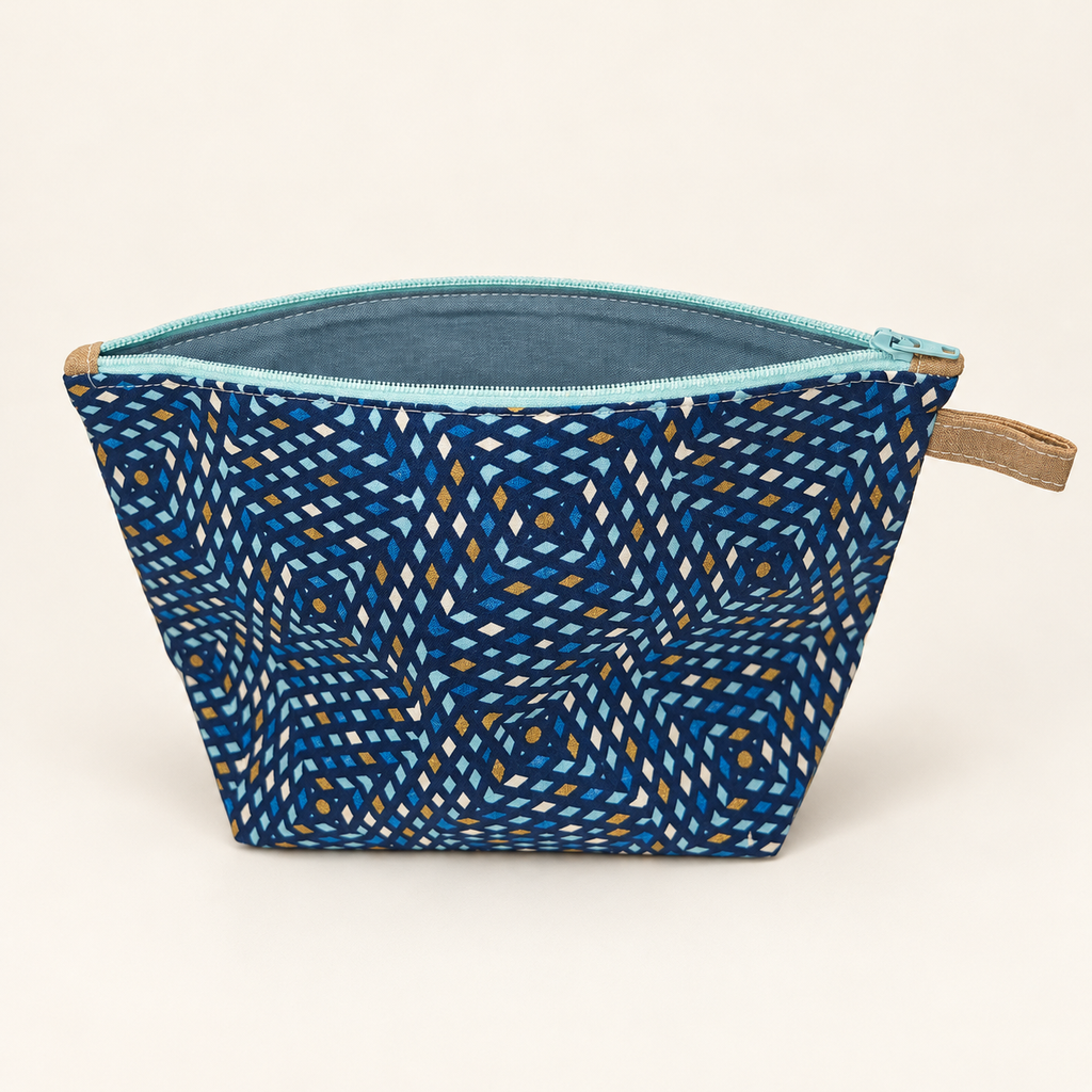 Blue by Design navy geometric cotton pouch with pale aqua zipper, standing view showing solid blue-gray lining