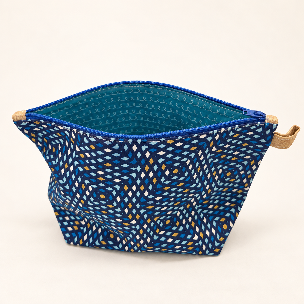 Blue by Design navy geometric cotton pouch with royal blue zipper, standing view showing teal loop-pattern lining