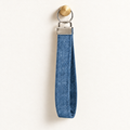 Blue Jean Energy – Fabric Wristlet Keychain hanging from a gold wall knob