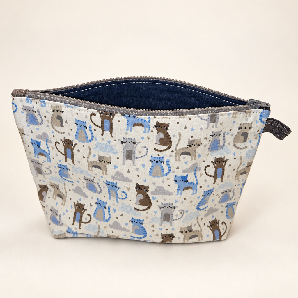Cat's Out of the Bag cotton pouch standing with navy lining and gray zipper.