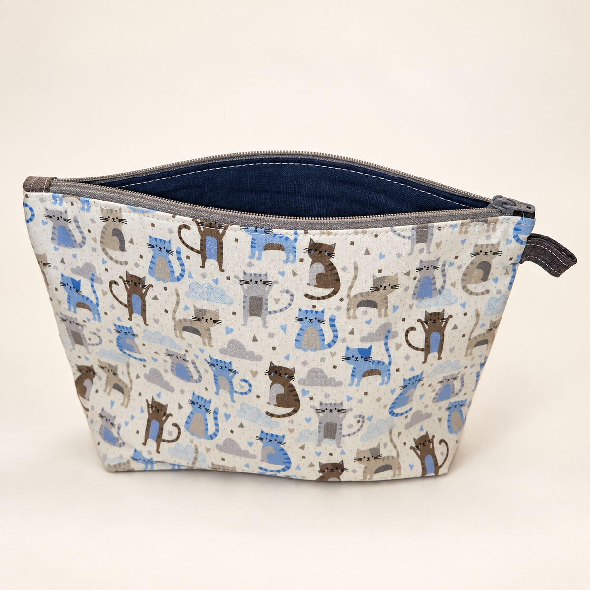 Cat's Out of the Bag cotton pouch standing with navy lining and gray zipper.