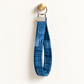 Check You Out – Fabric Wristlet Keychain hanging from a gold wall knob