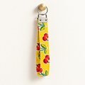 Cherry on Top – Fabric Wristlet Keychain hanging from a gold wall knob