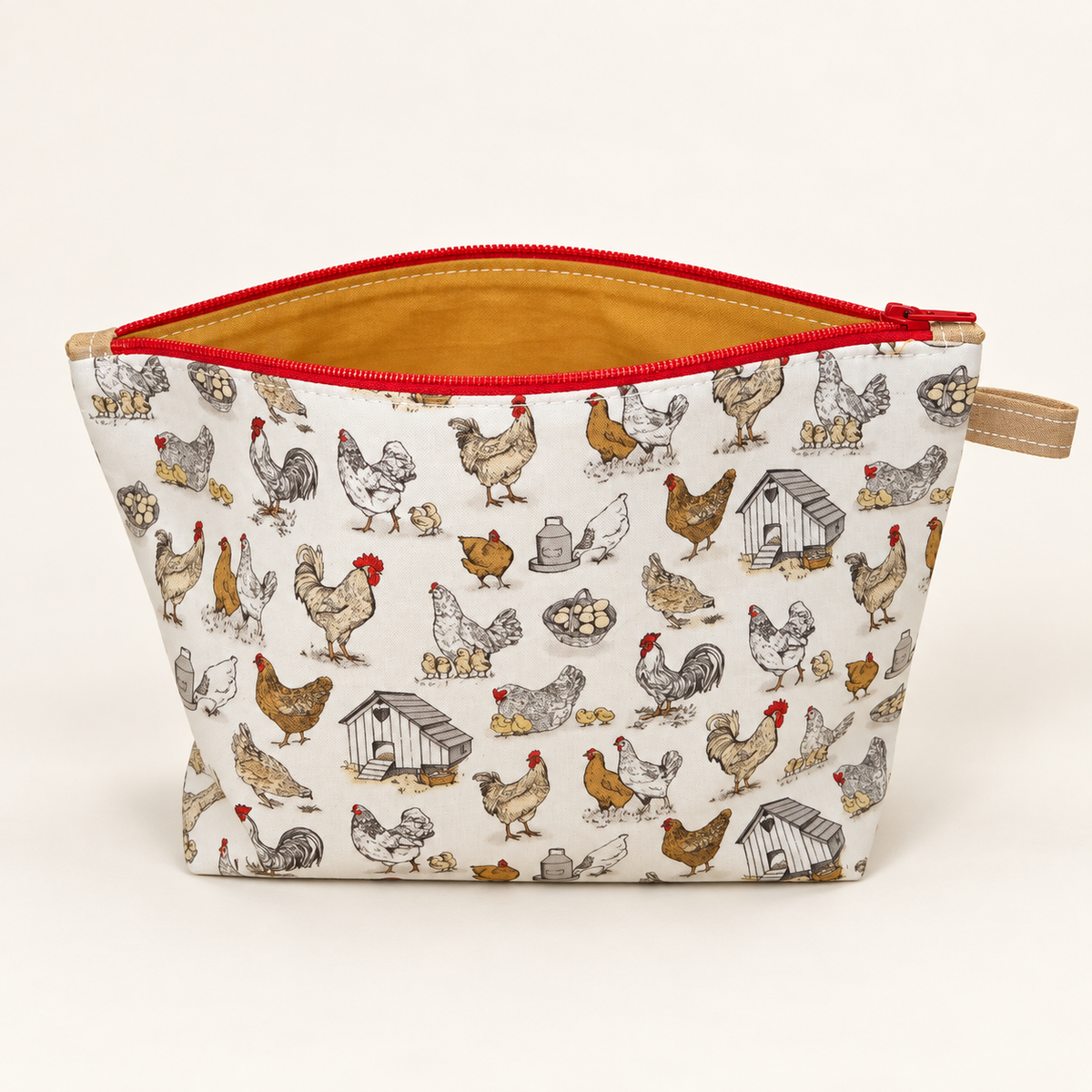 Cluck Around chicken print cotton pouch standing with mustard lining and red zipper.