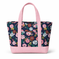 Cotton tote bag with navy floral print and blush pink straps and base, featuring a structured trapezoid shape and front exterior pocket