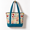 Wildflower Strawberry Cotton Tote Bag - Teal Accent, hanging from a gold wall knob