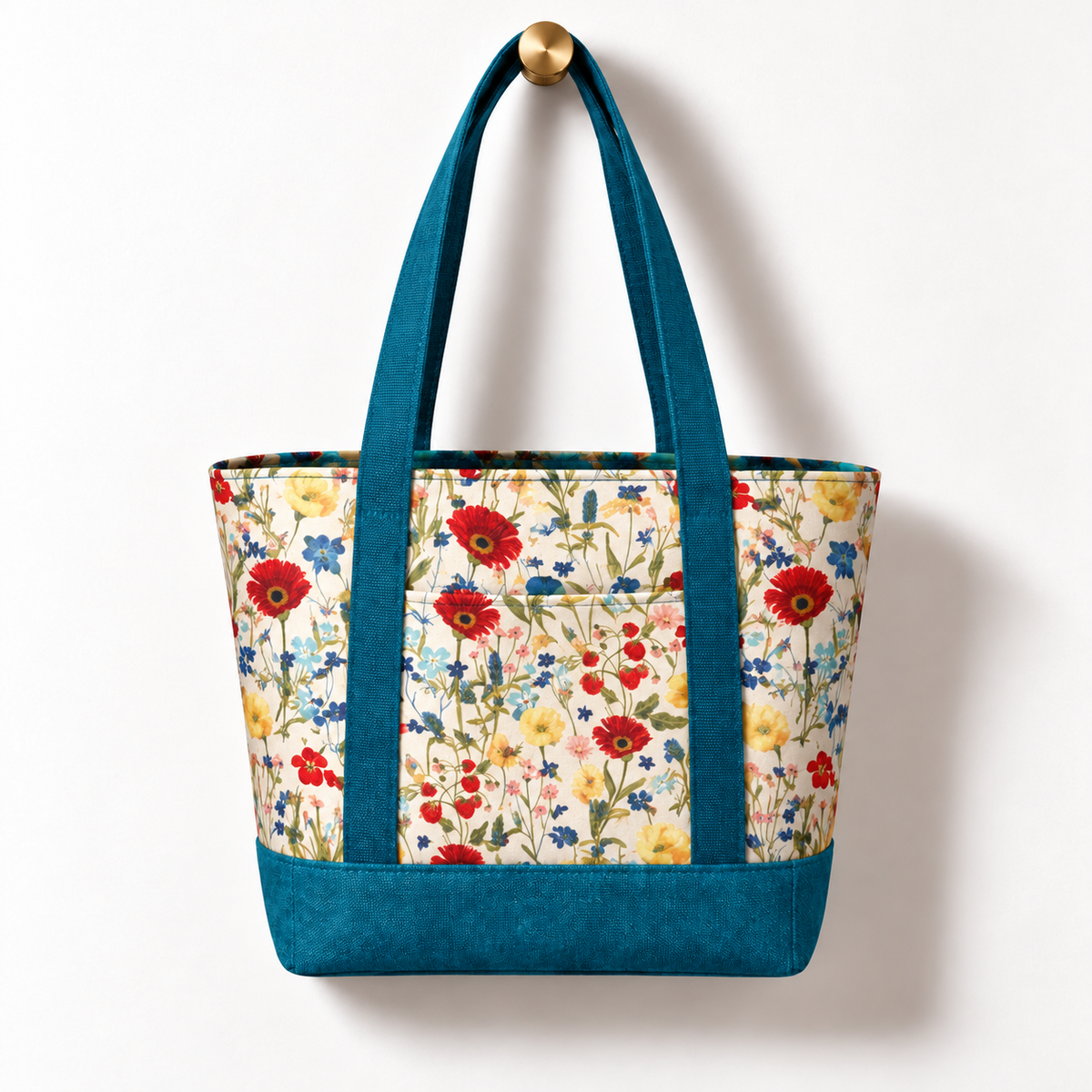 Wildflower Strawberry Cotton Tote Bag - Teal Accent, hanging from a gold wall knob