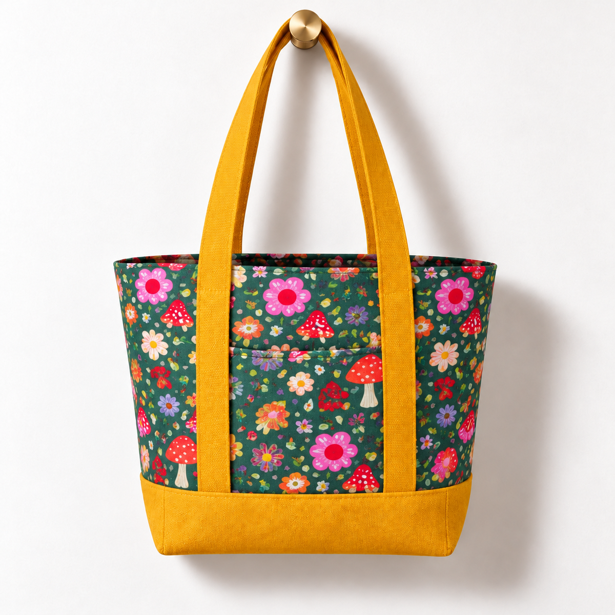 Whimsical Woodland Cotton Tote Bag - Mustard Yellow Accent, hanging from a gold wall knob