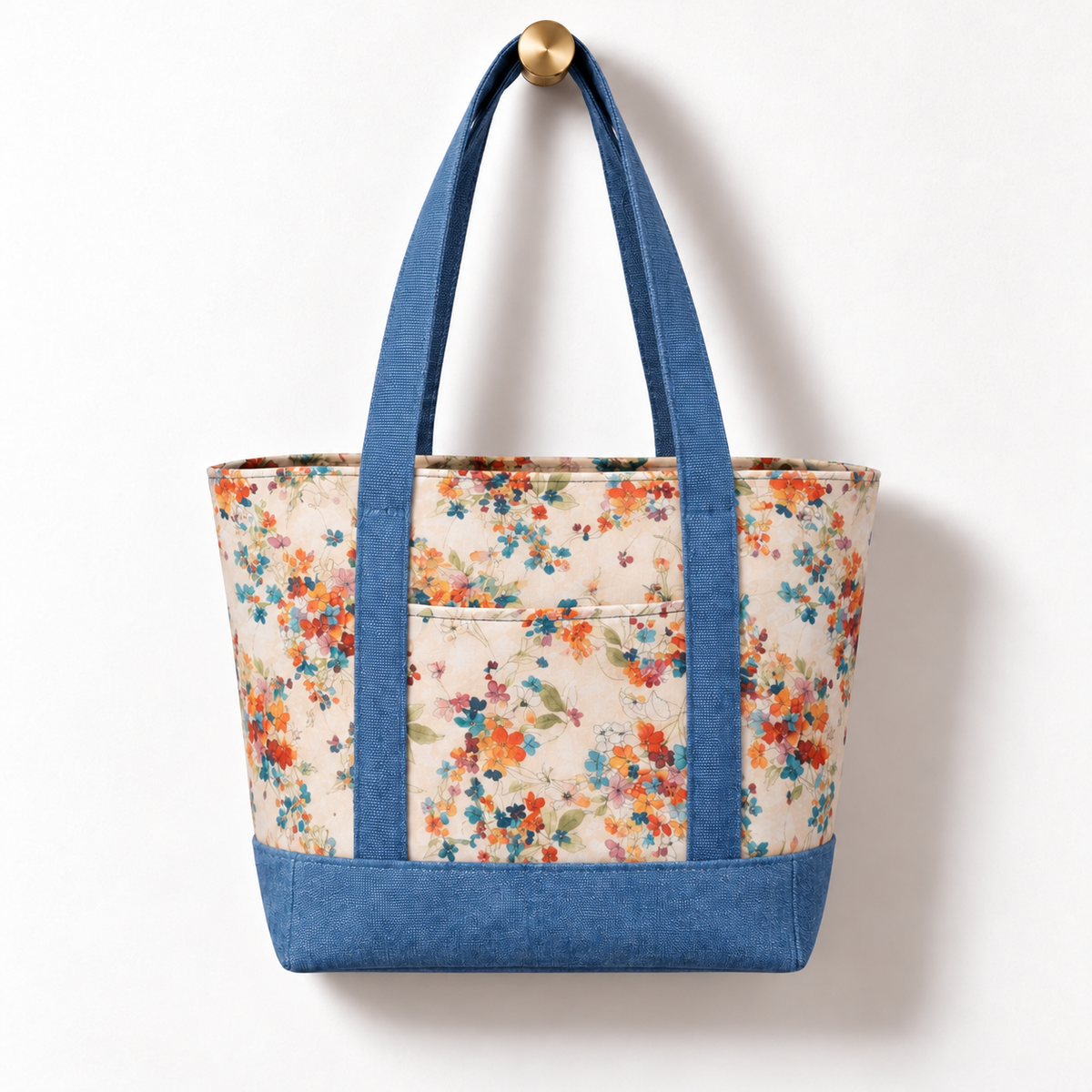 Soft Floral Cotton Tote Bag - Dusty Blue Denim Accent, hanging from a gold wall knob