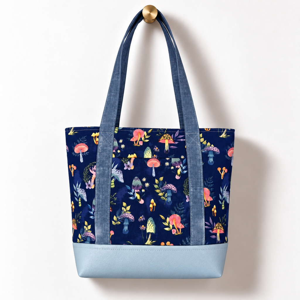 Enchanted Mushroom Cotton Tote Bag – Chambray & Powder Blue, hanging from a gold wall knob