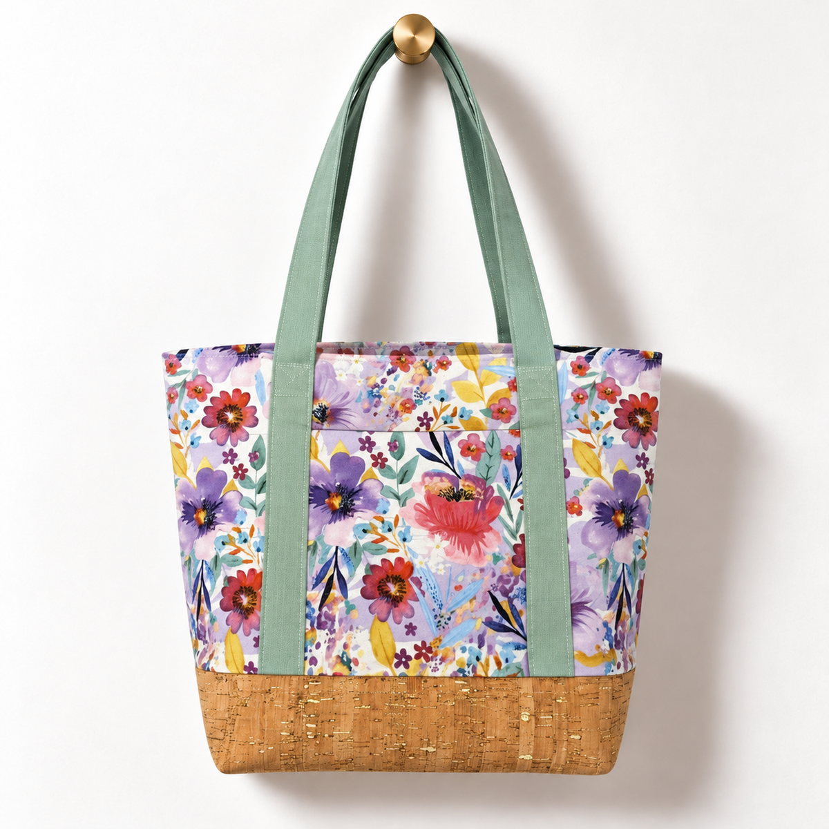 Watercolor Wildflower Cotton Tote Bag – Sage & Cork, hanging from a gold wall knob
