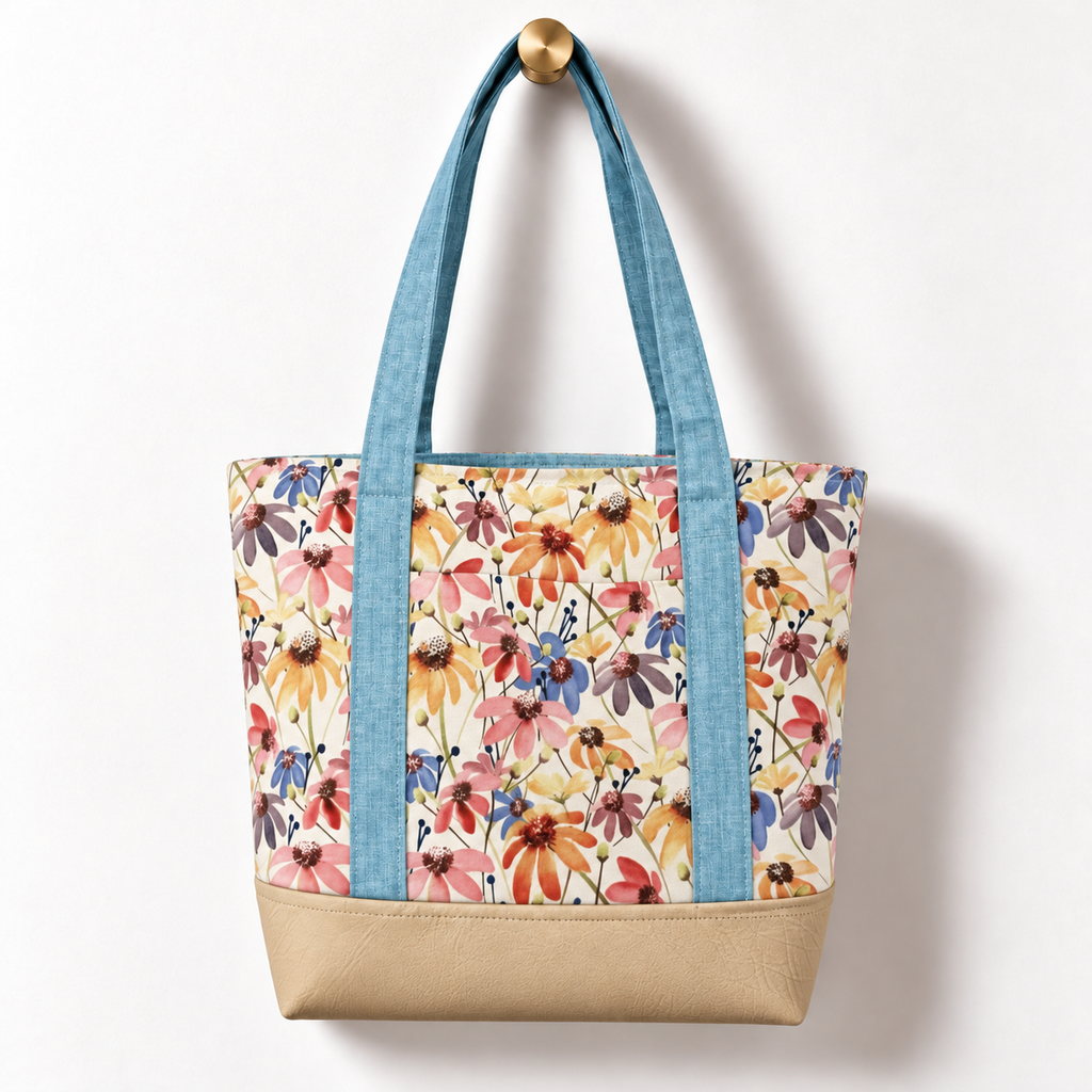 Wildflower Meadow Cotton Tote Bag – Sky Blue & Ivory, hanging from a gold wall knob
