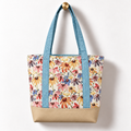 Wildflower Meadow Cotton Tote Bag – Sky Blue & Ivory, hanging from a gold wall knob