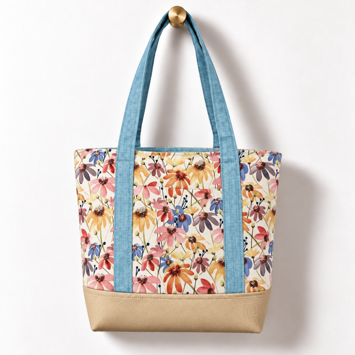 Wildflower Meadow Cotton Tote Bag – Sky Blue & Ivory, hanging from a gold wall knob