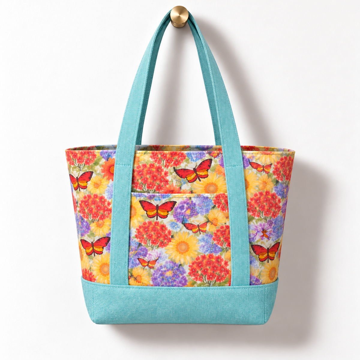 Wildflower Cotton Tote Bag - Dusty Blue, hanging from a gold wall knob