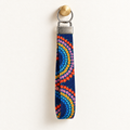 Full Circle – Fabric Wristlet Keychain hanging from a gold wall knob