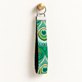 Full Plume – Fabric Wristlet Keychain hanging from a gold wall knob