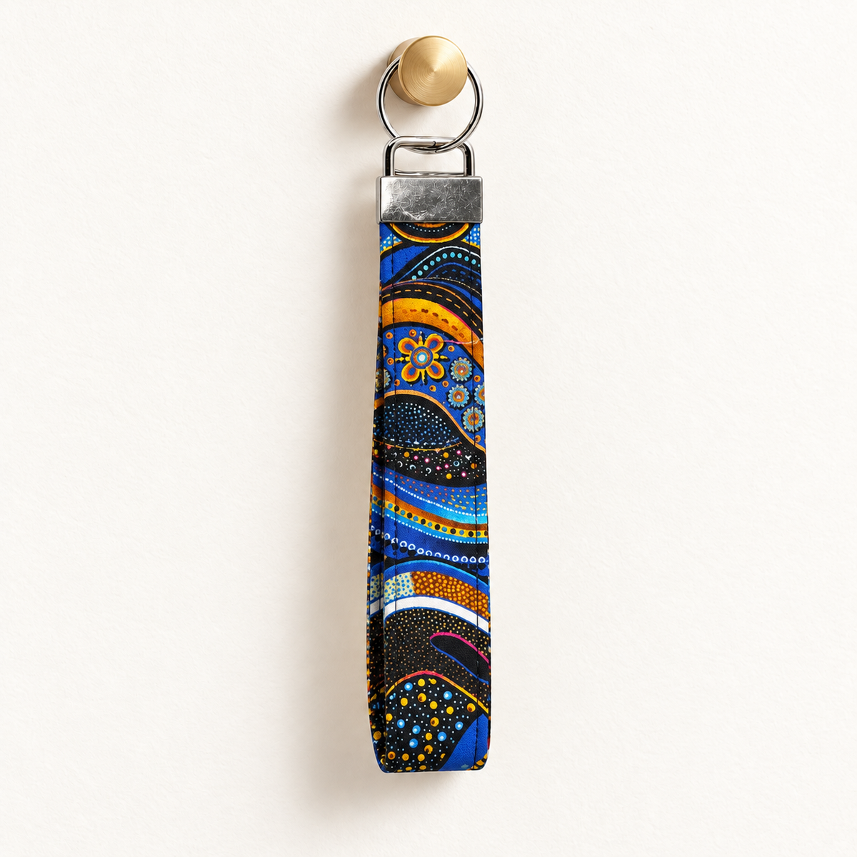 Go With the Flow – Fabric Wristlet Keychain hanging from a gold wall knob
