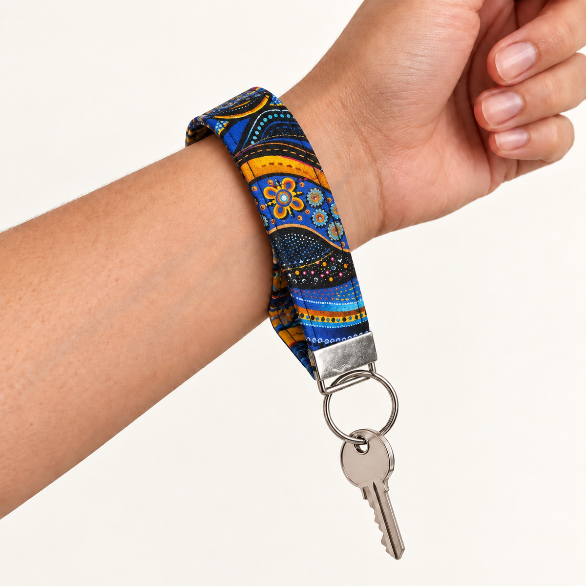Go With the Flow – Fabric Wristlet Keychain worn around a wrist with a key attached