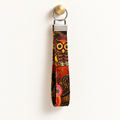 Hoot Stuff – Fabric Wristlet Keychain hanging from a gold wall knob