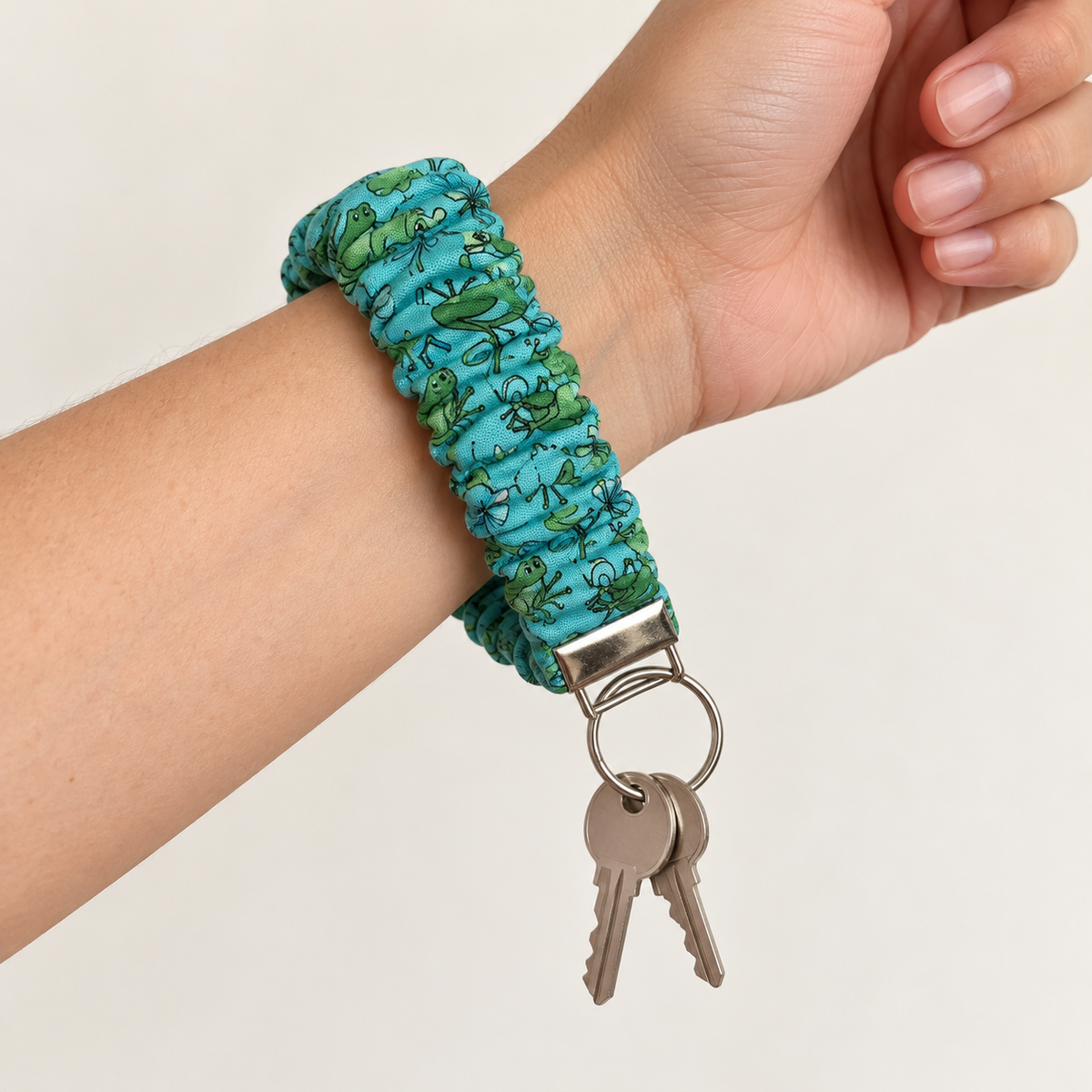 Hop to It scrunchie wristlet worn on a wrist with keys attached