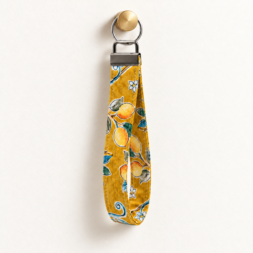 Lemon Main Character – Fabric Wristlet Keychain hanging from a gold wall knob