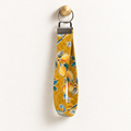 Lemon Main Character – Fabric Wristlet Keychain hanging from a gold wall knob