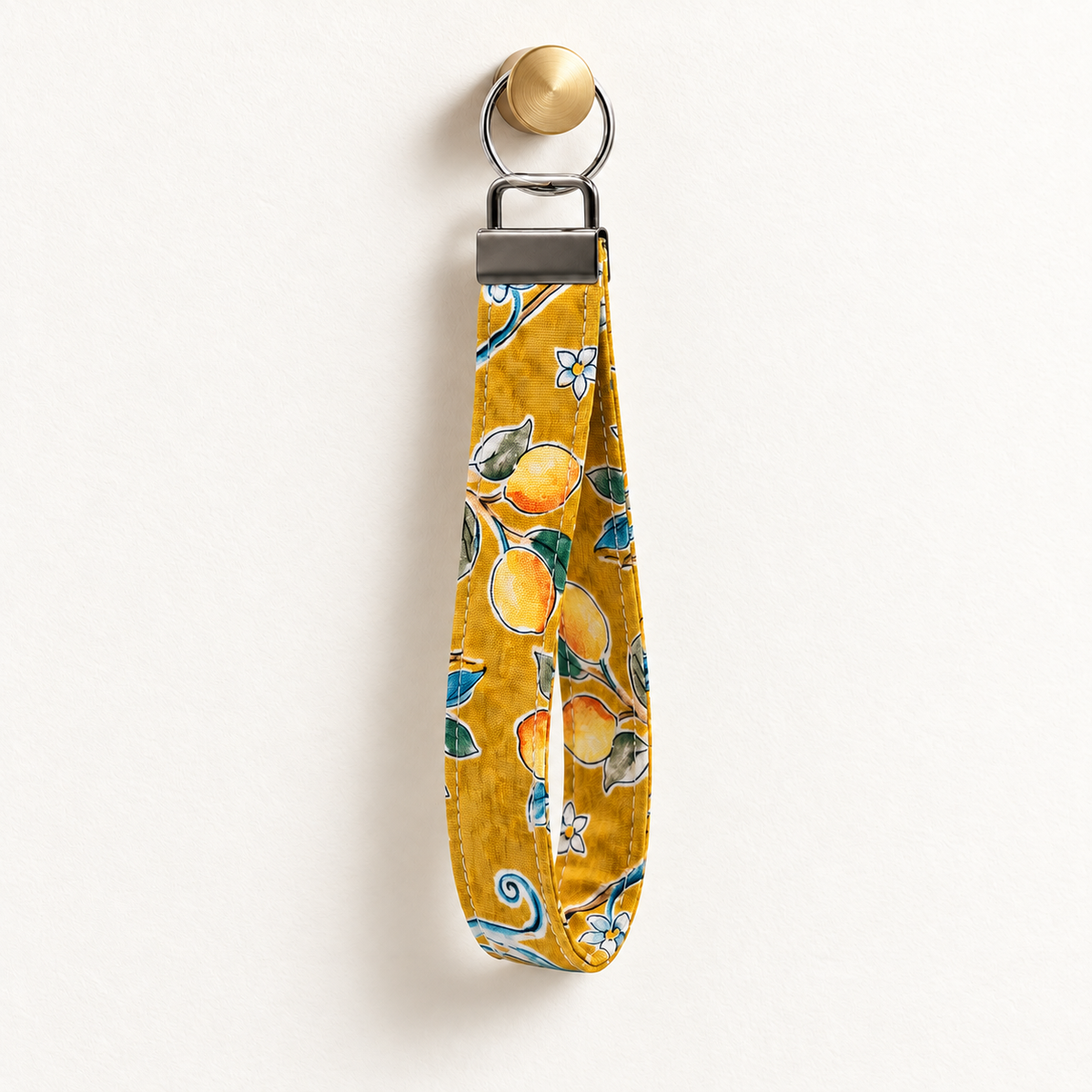 Lemon Main Character – Fabric Wristlet Keychain hanging from a gold wall knob