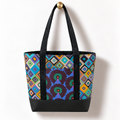 Handmade cotton tote bag with colorful retro diamond pattern and black straps hanging on a gold knob