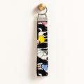 Party Animals – Fabric Wristlet Keychain hanging from a gold wall knob