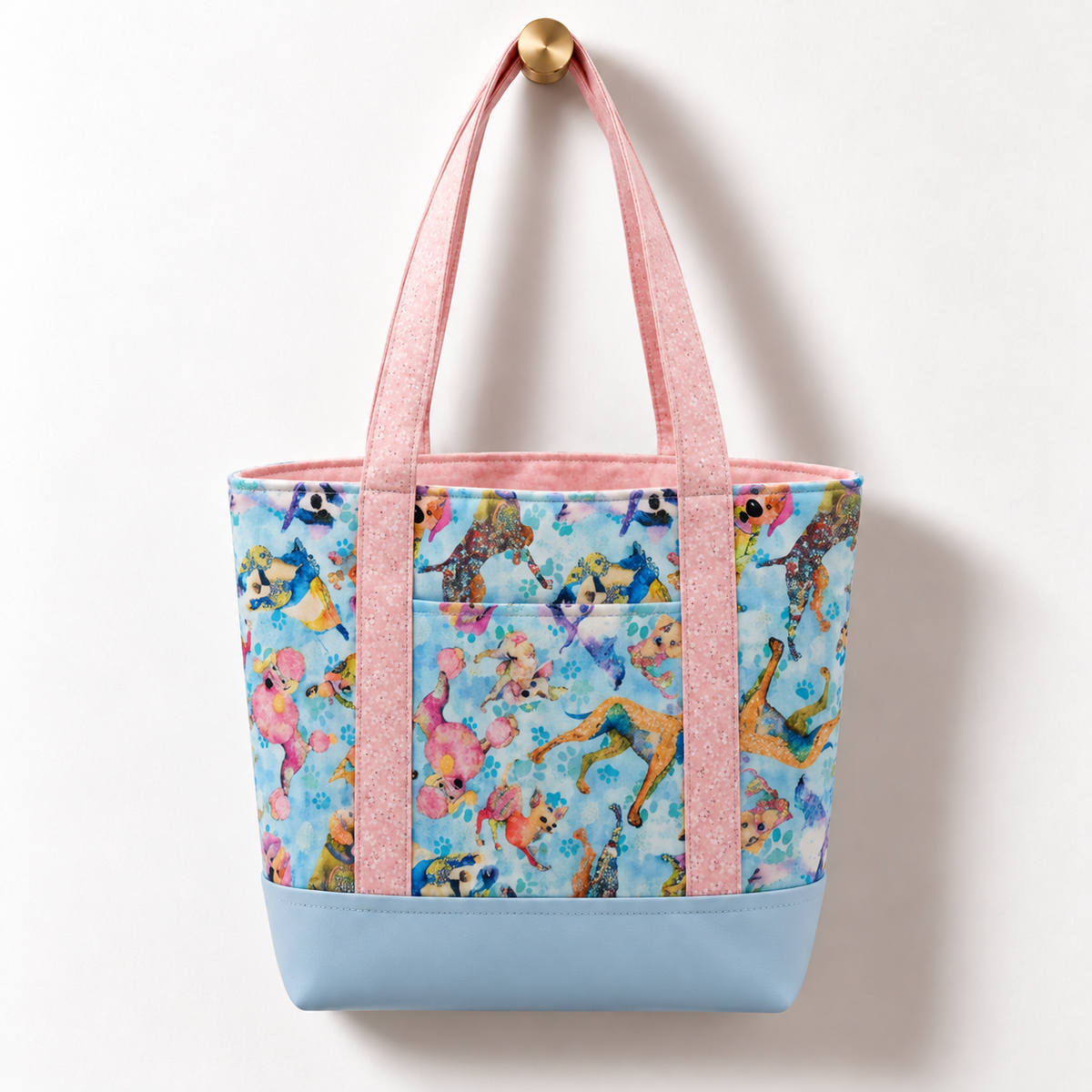 Pastel Watercolor Dogs Cotton Tote Bag – Powder Blue hanging on a gold knob