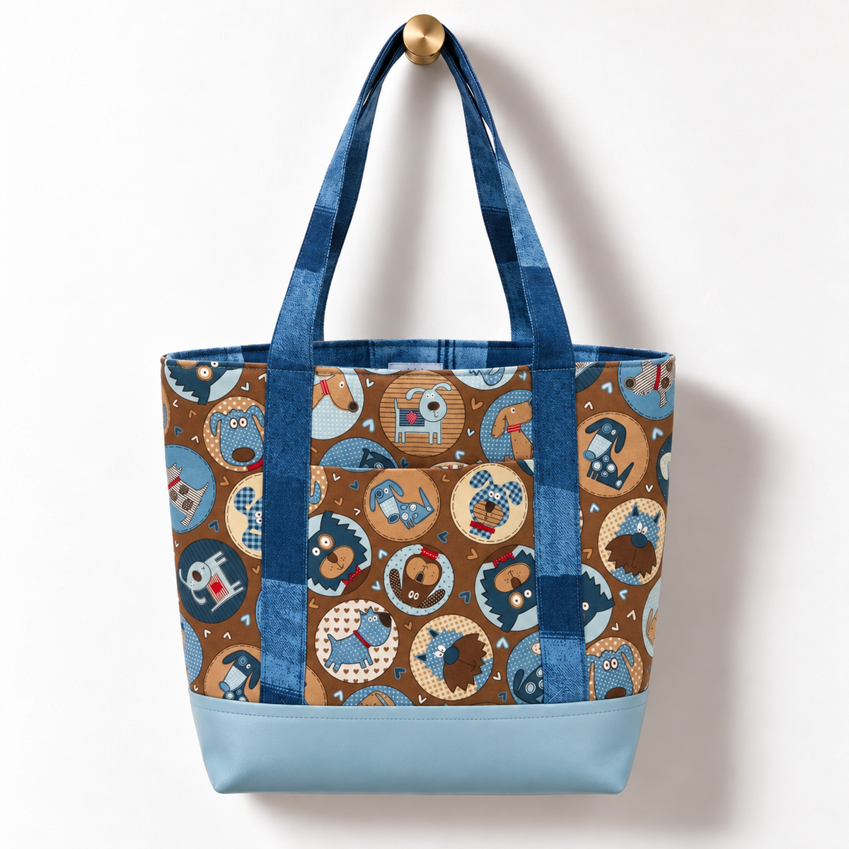 Retro Cartoon Dogs Cotton Tote Bag – Powder Blue hanging on a gold knob