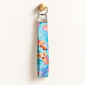 Paws in Color – Fabric Wristlet Keychain hanging from a gold wall knob