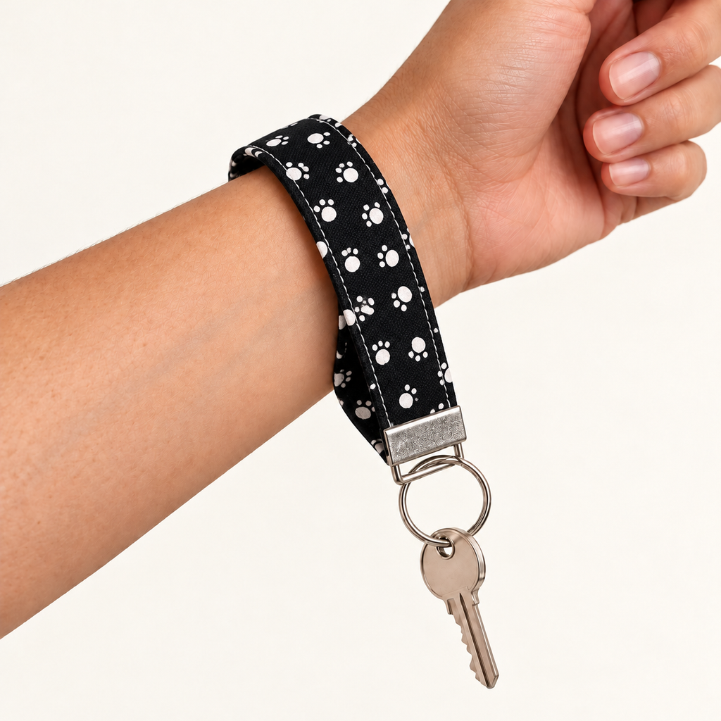 Paws Off – Fabric Wristlet Keychain worn around a wrist with a key attached