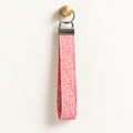 Pink Me Up – Fabric Wristlet Keychain hanging from a gold wall knob