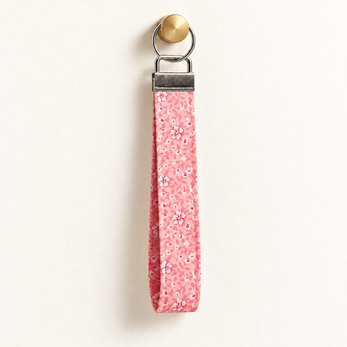 Pink Me Up – Fabric Wristlet Keychain hanging from a gold wall knob
